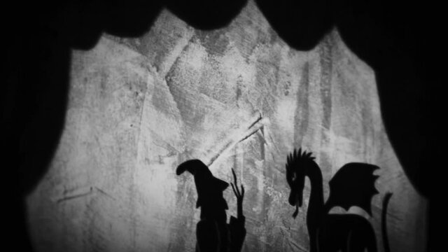 Vintage animation, shadow theatre on a wall. Pantomime, fantasy story. Halloween scene, black and white storytelling. Classic fable for children, creepy puppets.