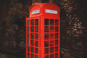 Obraz premium Vintage red telephone booth at public area