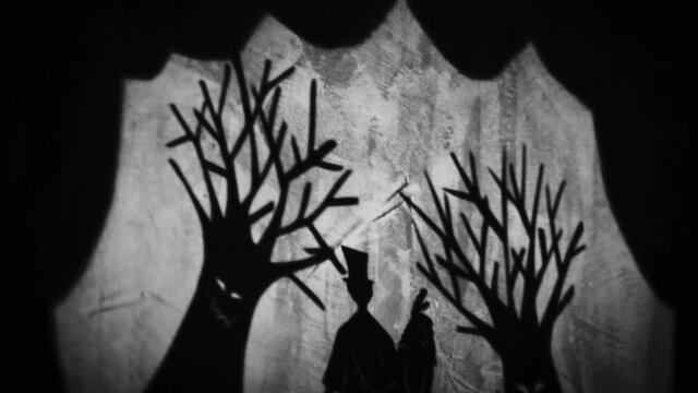 Vintage animation, shadow theatre on a wall. Pantomime, fantasy story. Halloween scene, black and white storytelling. Classic fable for children, creepy puppets.