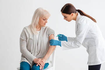 Senior Lady Receiving Coronavirus Vaccine Intramuscular Injection