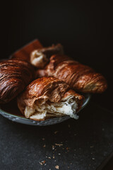 Three croissants on a white plate, rustic style