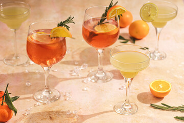 Orange christmas alcoholic beverage aperol spritz and lemonade with oranges, mandarins and rosemary...