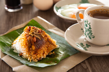 Oriental breakfast set in Malaysia consisting of coffee, nasi lemak, toast bread and half-boiled egg