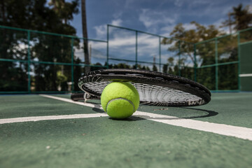 Tennis ball and racket on cort