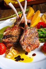 Lamb chops marinated in herbs with green asparagus and lime