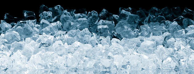 Ice cubes heap background pattern on black. Pieces of crushed ice cubes on black background.