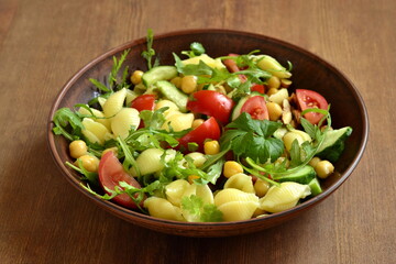 Mediterranean pasta salad with vegetables and chickpeas, copy space