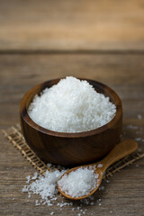 Natural salt in a wooden cup On the wooden table Ready to cook.