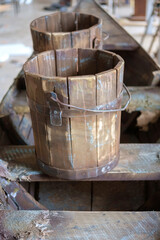 Naklejka na ściany i meble Old wooden buckets on wooden surface, selective focus