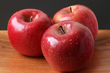 Fuji apples on a wooden plate, isolated