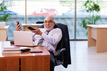 Old businessman employee working in the office