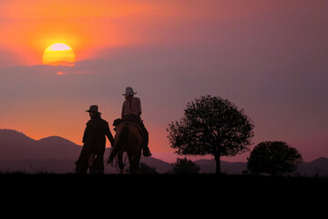 The silhouette of the cowboy and the setting sun
