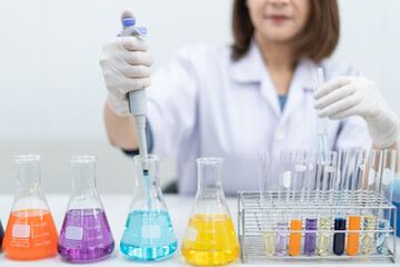 A young woman researcher, doctor, scientist, or laboratory assistant working with plastic medical...
