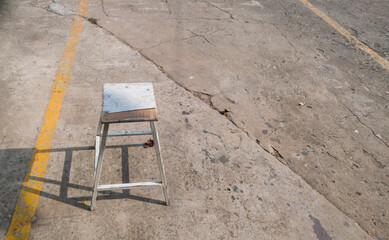 old hand-made chairs on a concrete floor