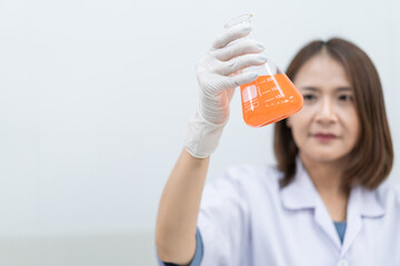 A young woman researcher, doctor, scientist, or laboratory assistant working with plastic medical tubes to research, examine scientific experiments in a modern laboratory. Education stock photo