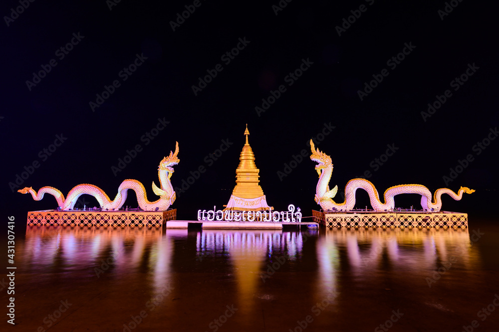 Wall mural White Naga statue with motion blurred water in Kwan Phayao Lake at night