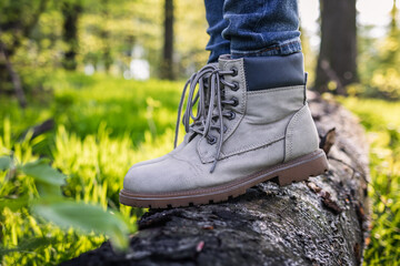 Hiking boot. Closeup leather sport shoes in forest