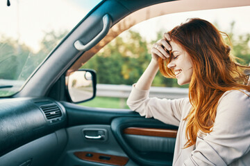 Fototapeta na wymiar happy woman in sweater driving on the front seat of a car clean interior design model