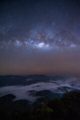 Milky way in the sky with the beautiful view of mountain and mist at night. Taken at Betong in Yala province in Thailand. - obrazy, fototapety, plakaty