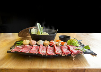 Set of shabu fresh raw meat beef, pork and condition with hot soup in black bowl