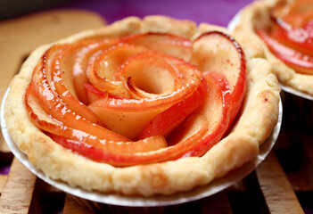 Obraz na płótnie Canvas Closeup of Freshly Baked Mouthwatering Homemade Rose Shaped Apple Tartlet