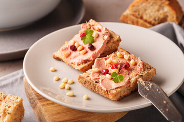 Toast bread with pate or mousse on table, nuts, berries - obrazy, fototapety, plakaty