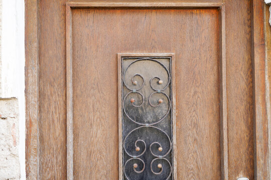 Old massive door with decorative door handle and lock, all still functional