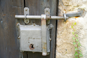 Old massive door with decorative door handle and lock, all still functional