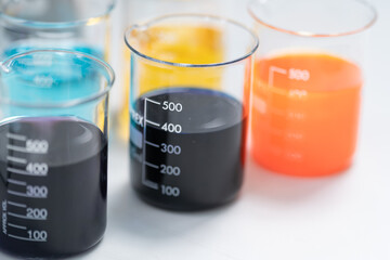 Close-up and selective focus shoot of a microscope, medical test tubes with liquid, and other modern laboratory equipment in a laboratory room. Education stock photo