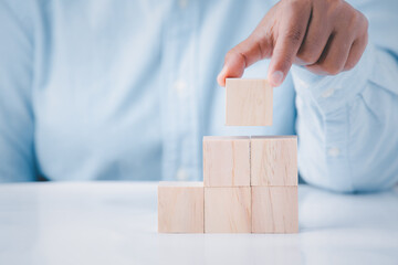 Business hand holding wooden block blank cubes creative idea on table, conceptual development business strategy  success background.