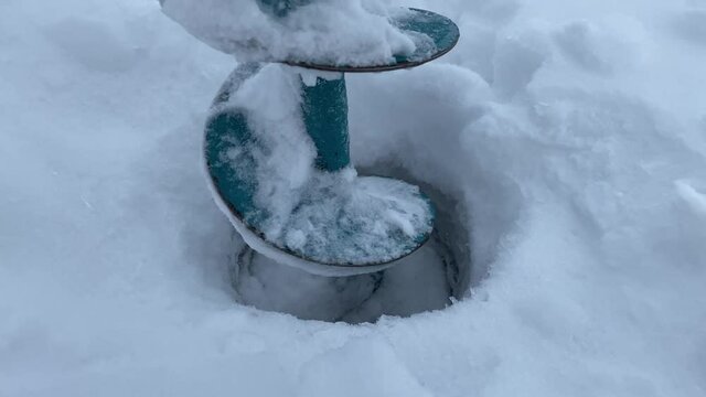 drilling holes in ice close-up