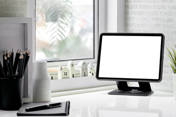 Mockup blank screen tablet on stand holder in modern room with copy space.