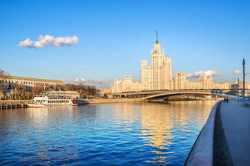 A skyscraper on Kotelnicheskaya embankment and a ship at the pier in Moscow