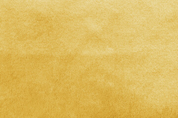 Gold velvet background or golden yellow velour flannel texture made of cotton or wool with soft...