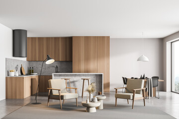 Light kitchen interior with armchairs, dining table near window, on grey floor
