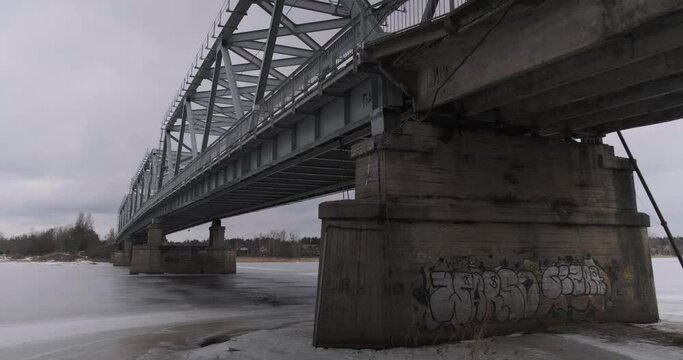bridge over the river in the village of Ust-Luga on a cloudy winter day