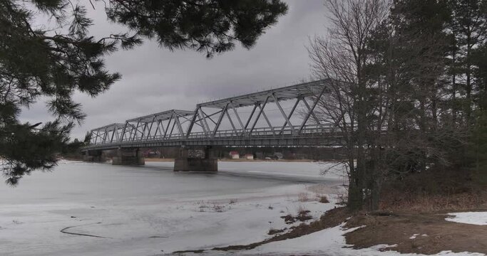 bridge over the river in the village of Ust-Luga on a cloudy winter day