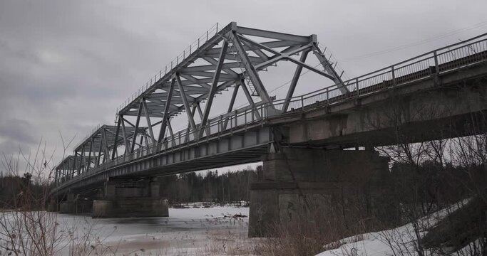 bridge over the river in the village of Ust-Luga on a cloudy winter day