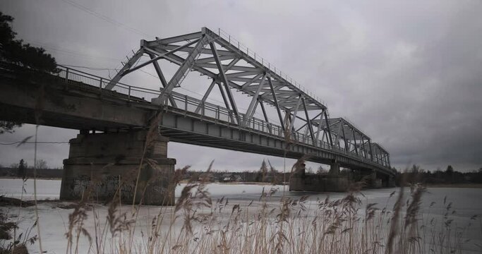 bridge over the river in the village of Ust-Luga on a cloudy winter day