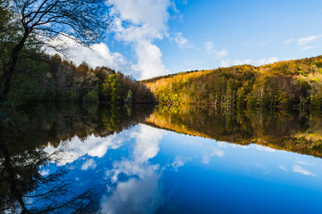 Obraz premium Reflections at the beautiful lake (Lake of Santa Fe, Montseny Natural Park, Catalonia, Spain)