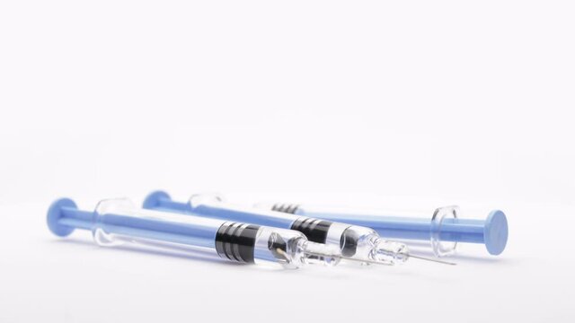 syringes with the vaccine or medical supplies on a white background (looping)
