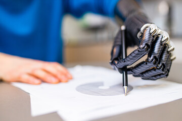 man with prosthetic hand writing development at home