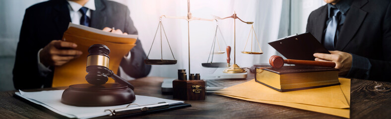 Justice and law concept.Male judge in a courtroom with the gavel, working with, computer and...