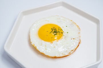 sprinkled with parsley powder fried egg with white background