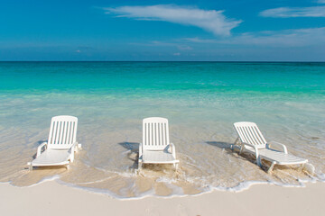 Empty chairs on a Caribbean beach