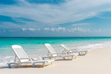 Empty chairs on a Caribbean beach