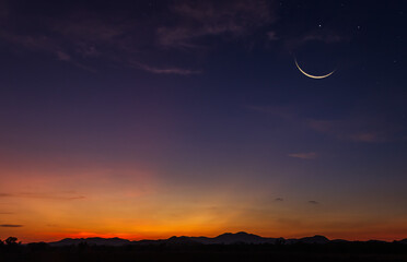 Crescent  moon sky on dark blue dusk in the evening with sunset and beautiful sunlight on dark cloud, symbols of Islamic religion in Ramadan - Powered by Adobe
