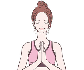 胸の前で手を合わせるスポーツインストラクター