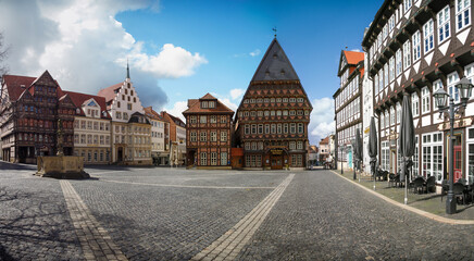 Fototapeta na wymiar wide panorama view of historic marketplace in Hildesheim, Germany, with blue sky