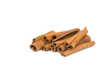 Stack of cinnamon sticks isolated on white background. Closeup, cinnamon sticks a lot.